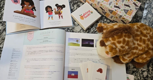 The French Level 1 textbook, puppet, storybook, and flashcards set out on a table.