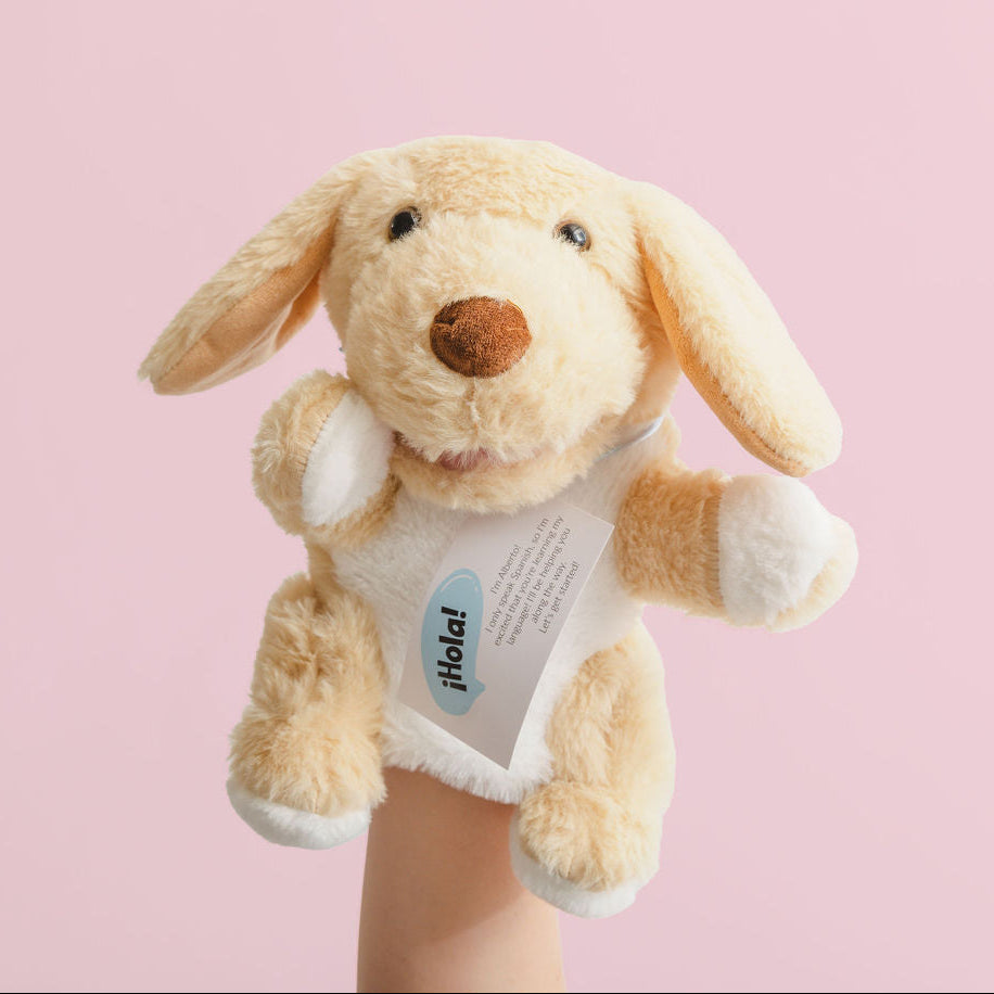 Plush dog toy with a heart label on a pink background