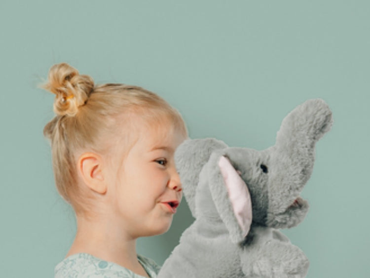Child playing with Beto the elephant, the Brazilian Portuguese puppet
