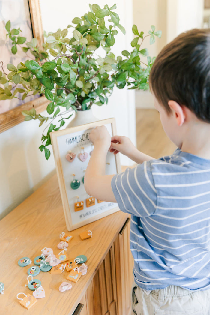 Boy choosing tags on the prayer board
