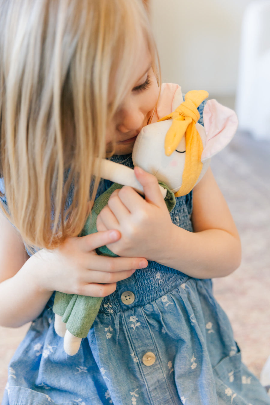 Girl snuggling the Prayer Mouse